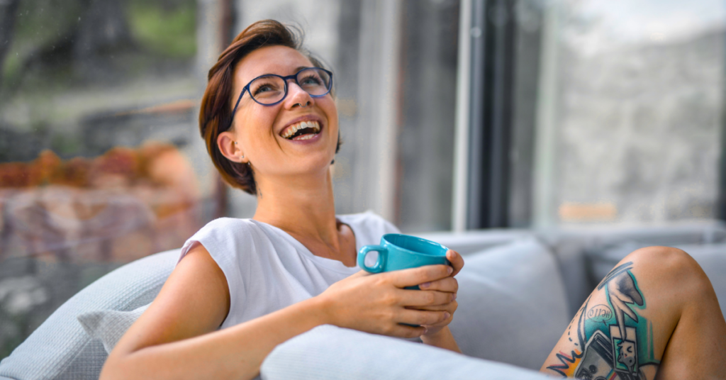 woman holding a mug smiling