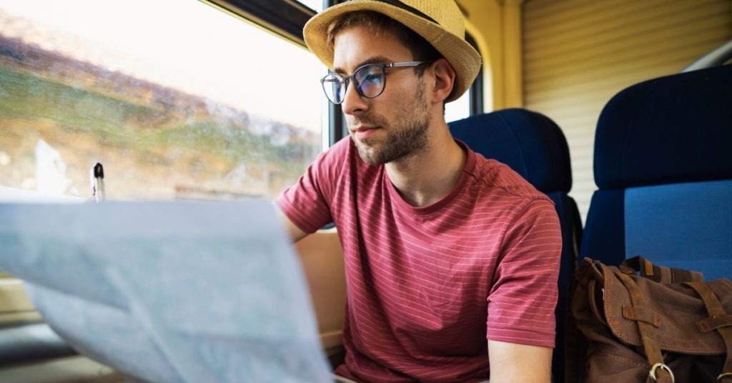 man on a coach holding a map