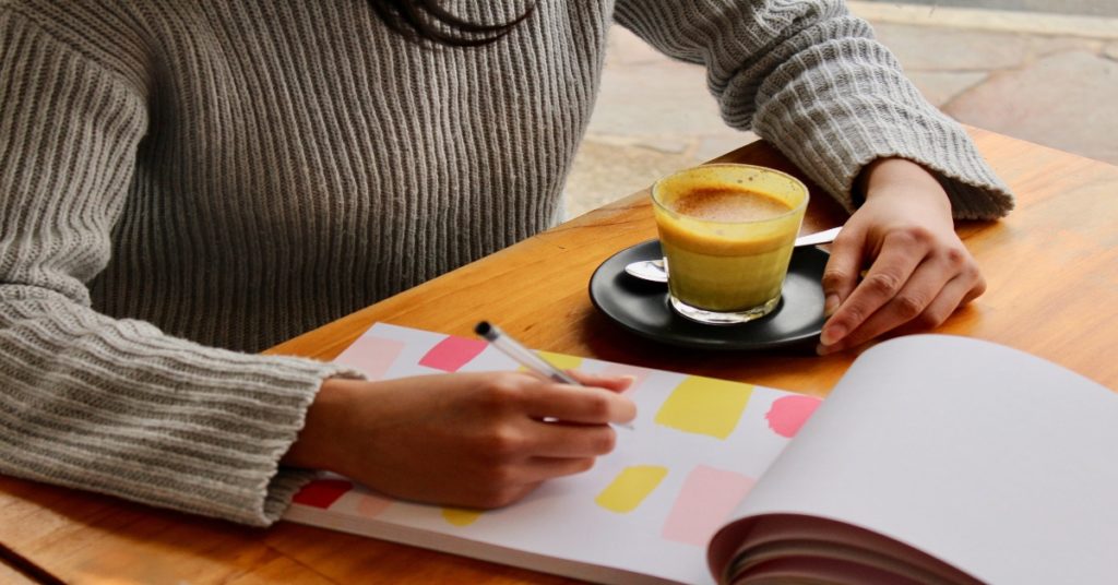 Woman planning on a notepad to get weight loss motivation.