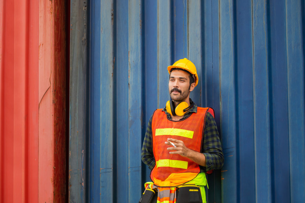 Factory worker with a cigarette smoke break