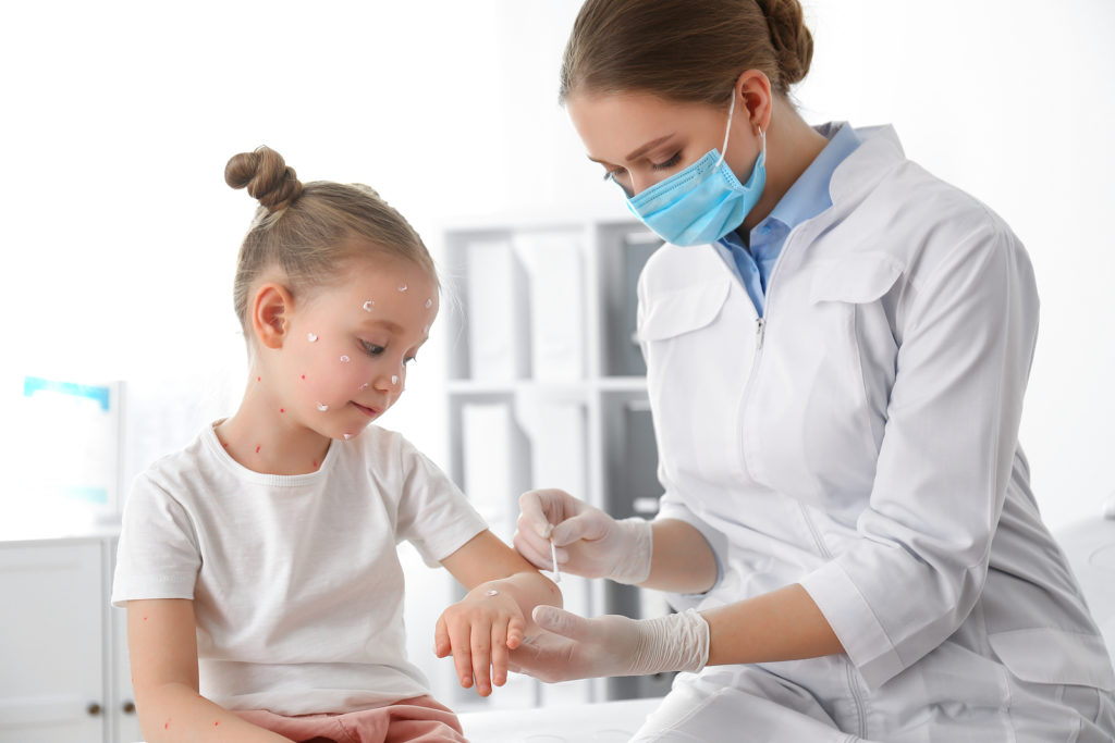 Doctor Applying Cream Onto Skin Of Little Girl With Chickenpox I